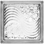 Vidrio block 19x19x8-transparente-oceano-foncer-plomeria garcia-ok | Plomería García Close-up of a square glass dish with bubbles and curved grooves creating an abstract pattern.