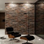 Mid-century modern lounge: black leather eames chair and ottoman, glass coffee table, textured stone wall.