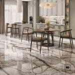 Piso ceramico color plata-60x60-brillante-interior-supreme-lamosa-2-ok | Plomería García Modern open kitchen with marble floor, gray cabinets, and a round wooden dining table with six chairs under a cluster of pendant lights.